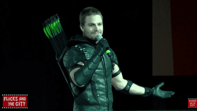 Stephen Amell shows off the new Green Arrow costume on stage